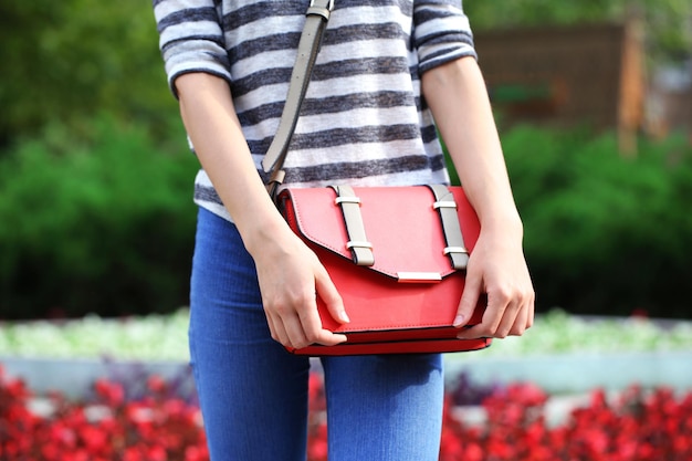 Girl with bag over his shoulder outdoors