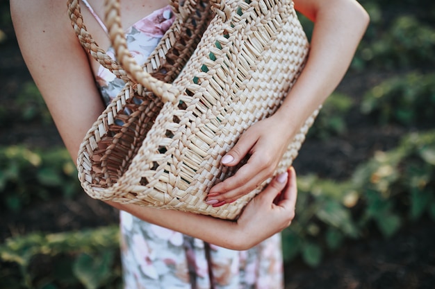 Girl with a basket in the field