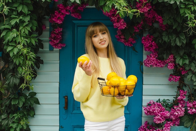 Girl with a basket of lemonsGardening concept lemonade advertisement