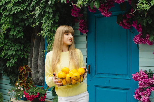 Girl with a basket of lemonsGardening concept lemonade advertisement