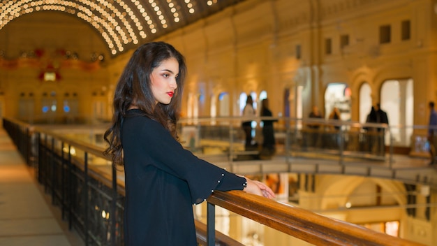 A girl with a beautiful figure in a shopping center