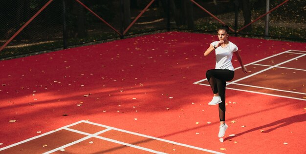 girl with black hair  training by herself on stadium