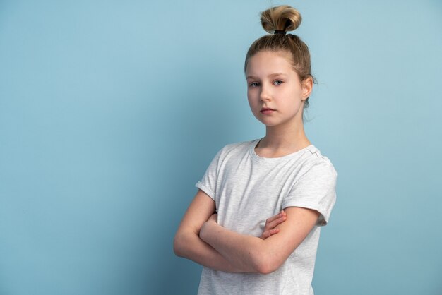 Girl with blond hair on a blue wall