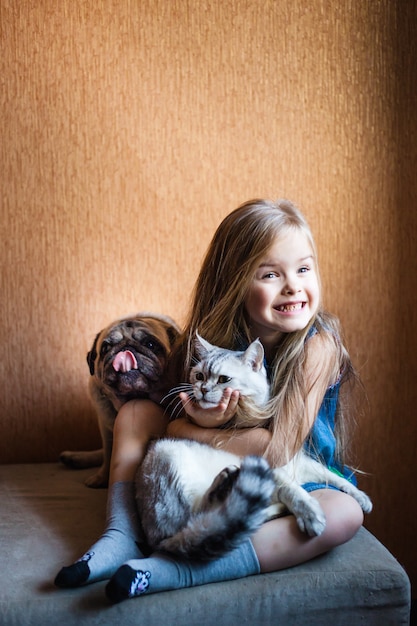 Girl with blond hair holds a cat