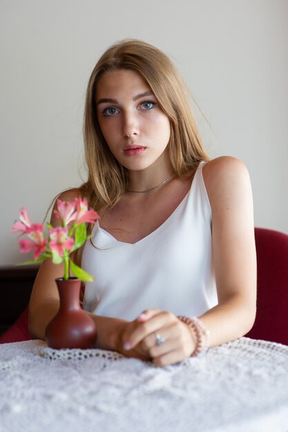 Girl with blue eyes sitting on urban cafe. woman with brown wavy hairstyle. Lifestyle concept.