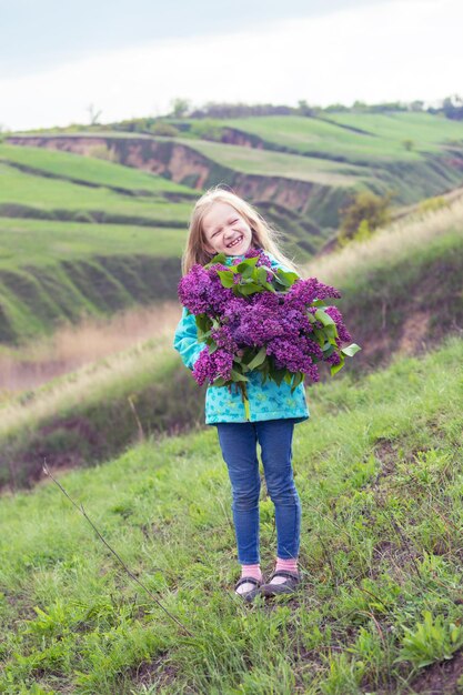 Girl with a bouquet of lilacs