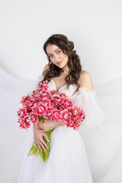 Girl with a bouquet of pink tulips Girl with a gift of flowers