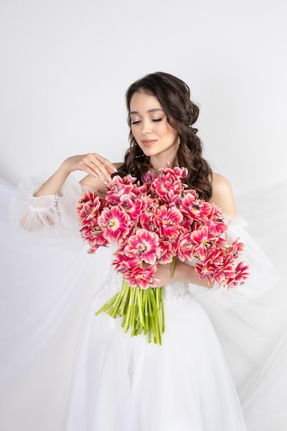 Girl with a bouquet of pink tulips Girl with a gift of flowers