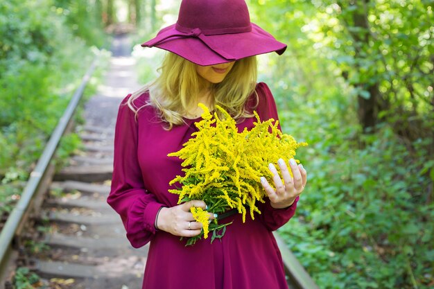 Girl with a bouquet of yellow flowers