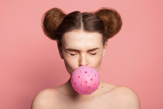 Girl with bubble gum in sparkles