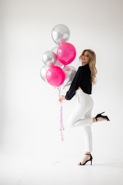 A girl with a bunch of balloons