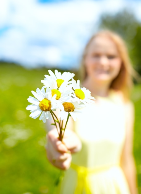 Girl with bunch of camomiles.