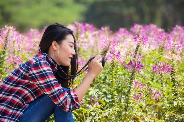 Girl with camera on meadow 