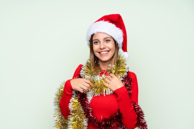 Girl with christmas hat over isolated green