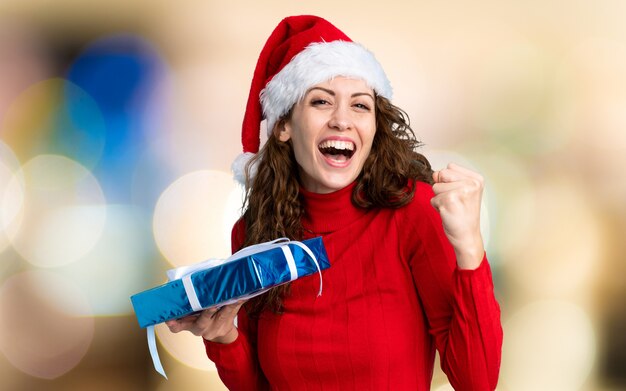 Girl with christmas hat on unfocused wall