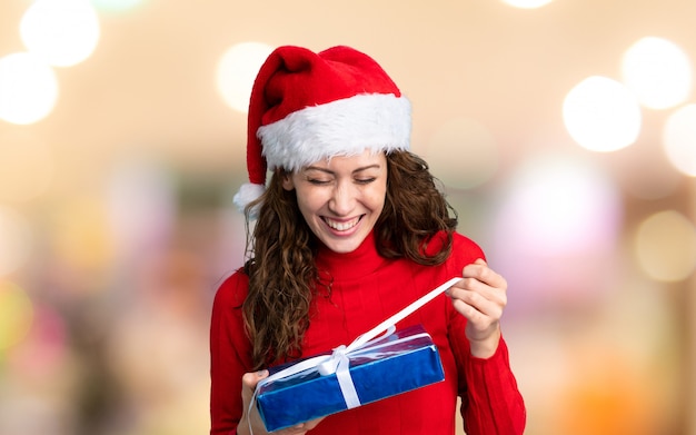 Girl with christmas hat on unfocused wall