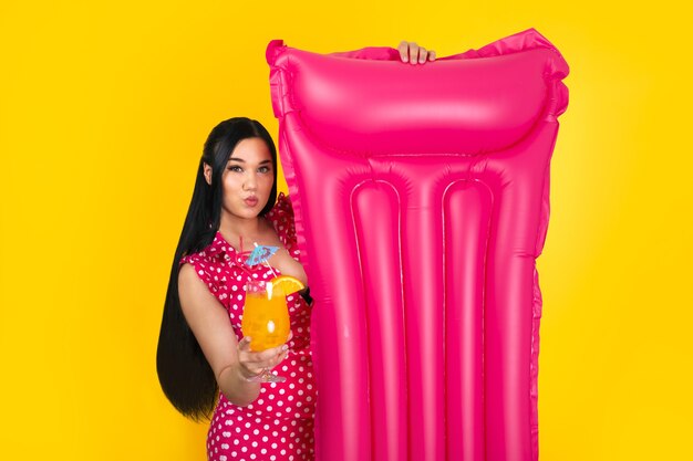 Girl with cocktail and swimming mattress