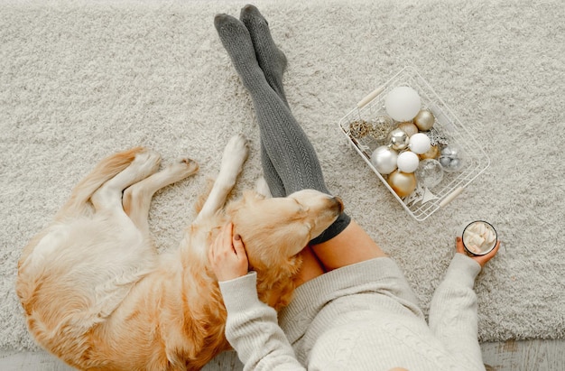 Girl with cocoa and golden retriever dog