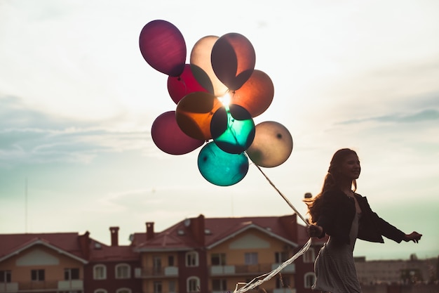 Girl with colorful balloons