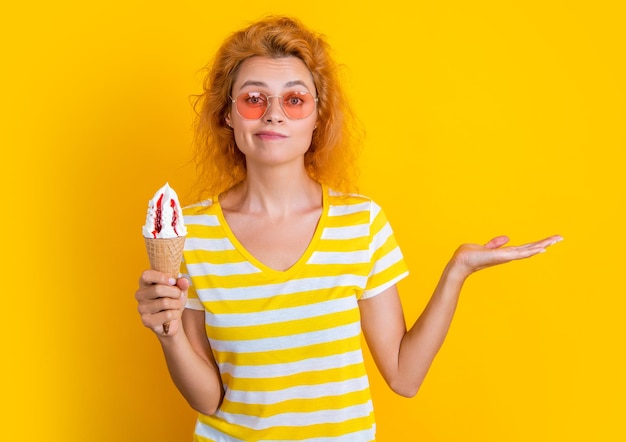 girl with cone icecream isolated on yellow presenting product girl with cone icecream in studio girl with cone icecream on background photo of girl with cone icecream at summer