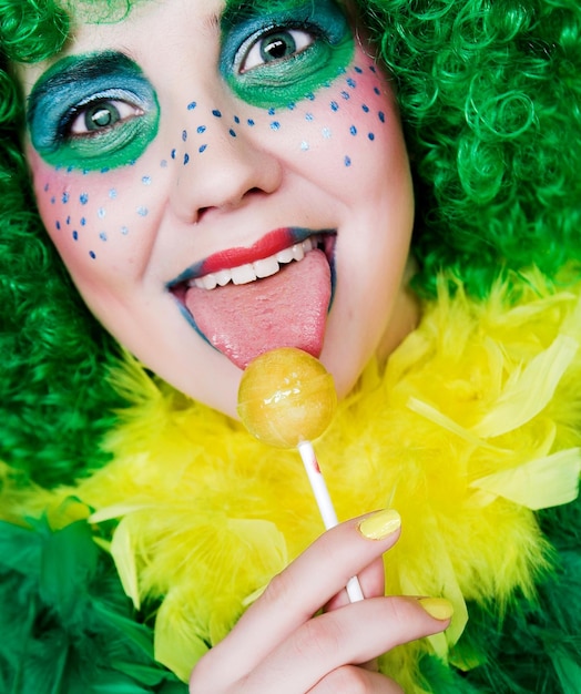 Girl with creative visage with lollipop