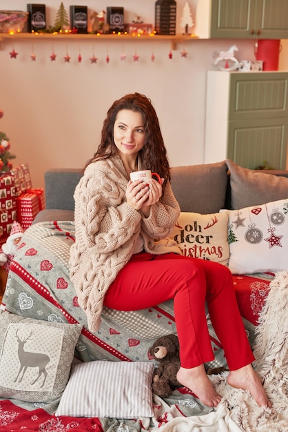 girl with a cup of marshmallow in the New Year's interior at home