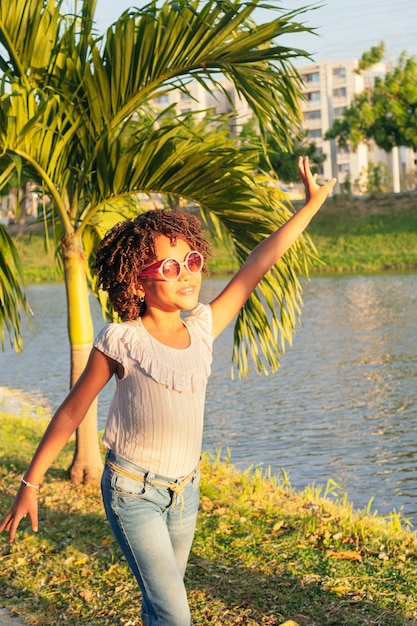 Girl with curly hair having fun at the park