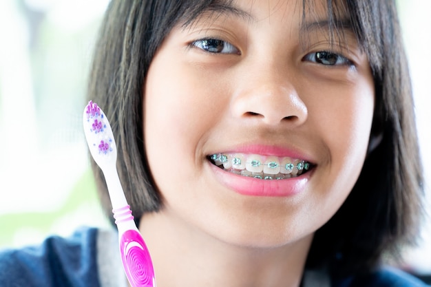 Girl with dental braces smiling and happy