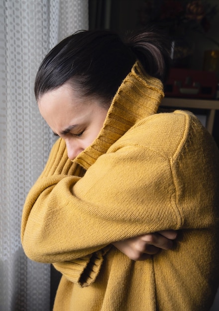 Girl with dirty hair is sick. Feeling lonely. Depression. Wears yellow sweater with neck