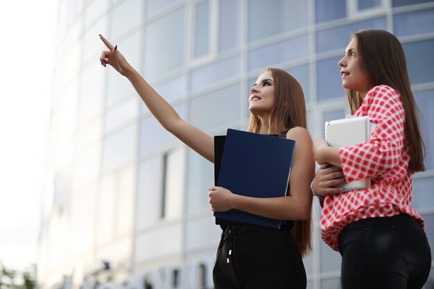 Girl with documents at a business meeting near a modern building