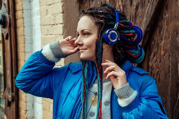 Girl with dreadlocks in headphones