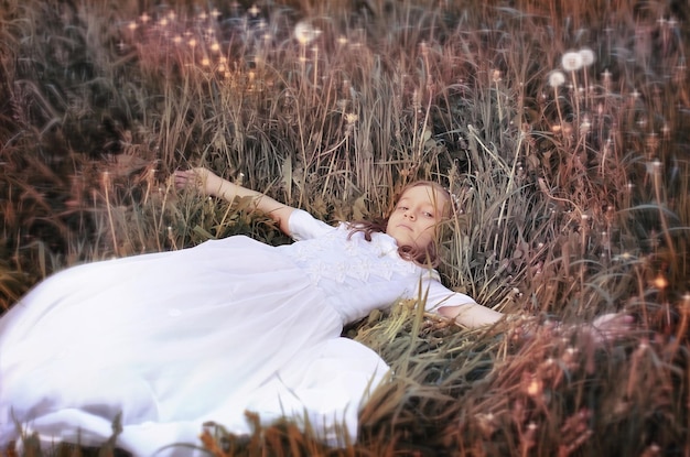 Girl with dundelion in autumn park