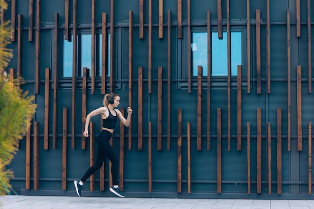 Girl with earphones running jogging