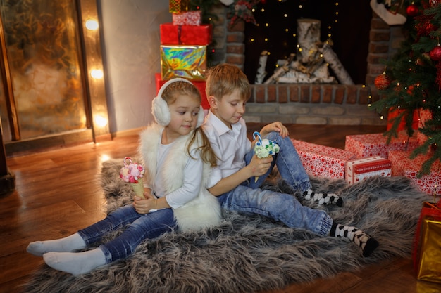 Girl with envy looks at a horn of sweets in the hands of a boy