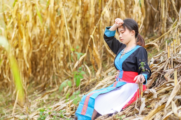 girl with eyes closed sitting by plants