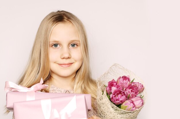 Girl with gift box and flowers