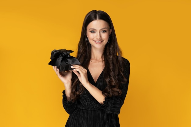 Girl with a gift on a yellow background