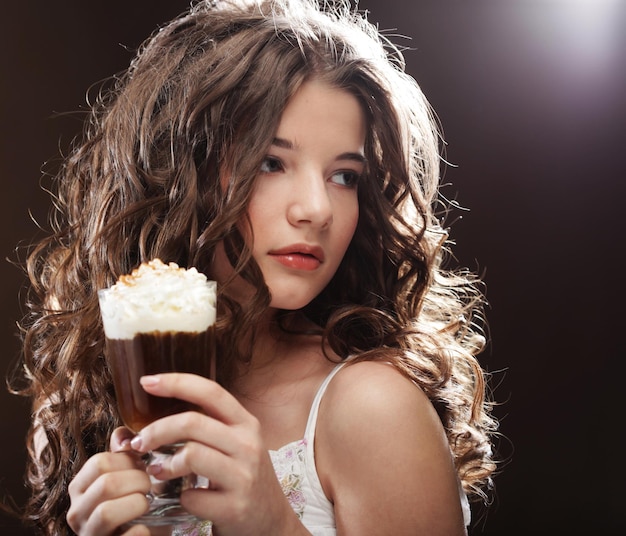 Girl with glass of coffee witn cream