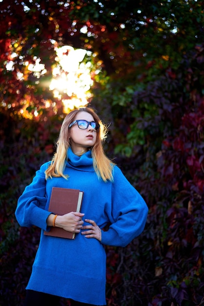 girl with glasses and books autumn