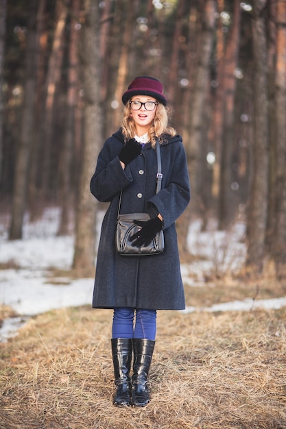 Girl with glasses watching in a forest