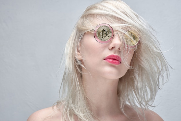 girl with glasses with bitcoins on white background