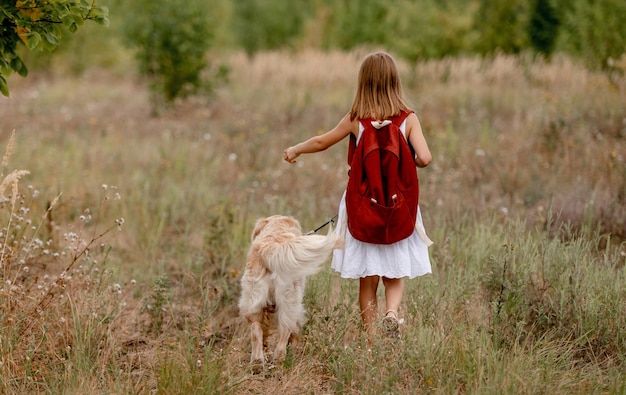 Girl with golden retriever dog