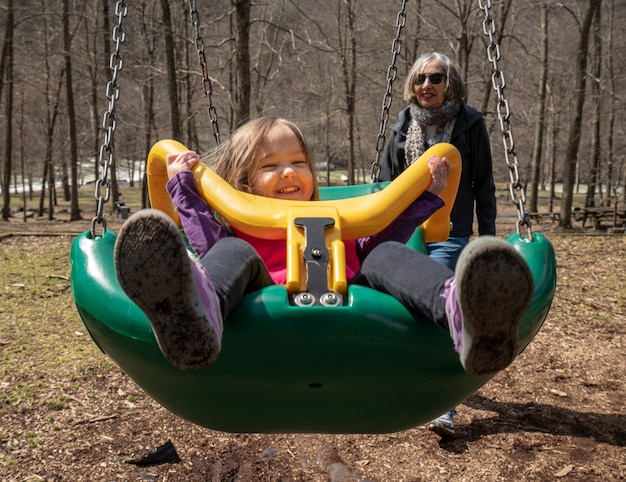 Photo girl with grandmother on swing