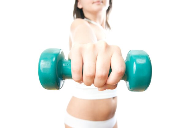 Girl with green dumbbells in hand isolated on white