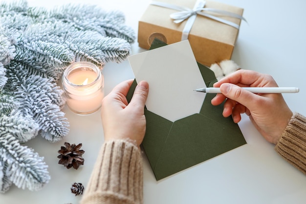 Girl with a greeting card in her hands writes a congratulation