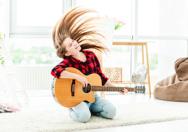 Girl with guitar waving long hair