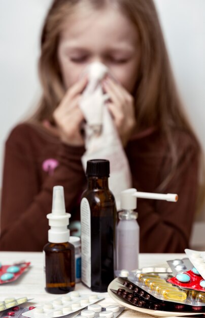 Photo girl with a handkerchief and pills in the foreground