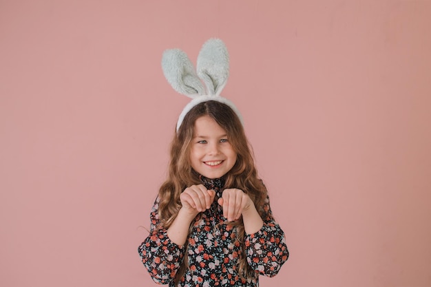 Girl with hare ears on a pink background