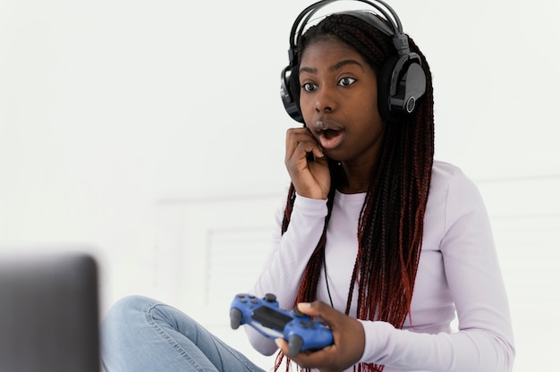 Photo girl with headphones playing videogame