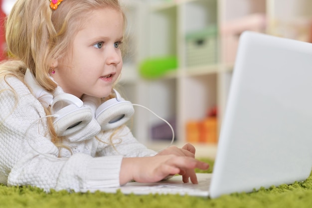 Girl with headphones using laptop